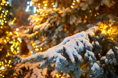 Sokakta süslenmiş Noel ağacı Toplar, oyuncaklar, lambalar ve çelenkler