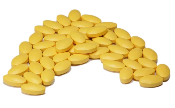 白い背景に黄色のビタミン — ストック写真
