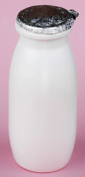 Witte fles op roze achtergrond — Stockfoto