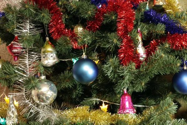 Many of toys on green christmas fir — Stock Photo, Image