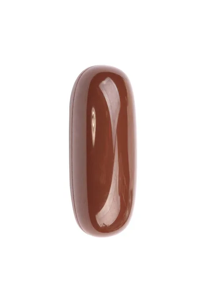 Una pillola di gelatina marrone isolato su backgroung bianco — Foto Stock