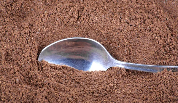 Milled coffee  and teaspoon — Stock Photo, Image