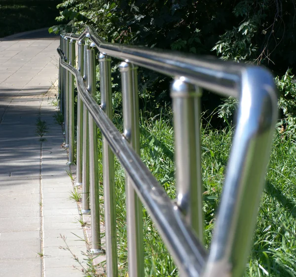 Metallzaun im Park an trockenen, sonnigen Sommertagen — Stockfoto