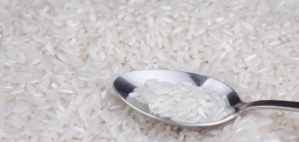 Rice food background and teaspoon — Stock Photo, Image