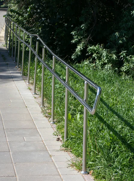 Metal fence in park at dry sunny summer day — Stock Photo, Image