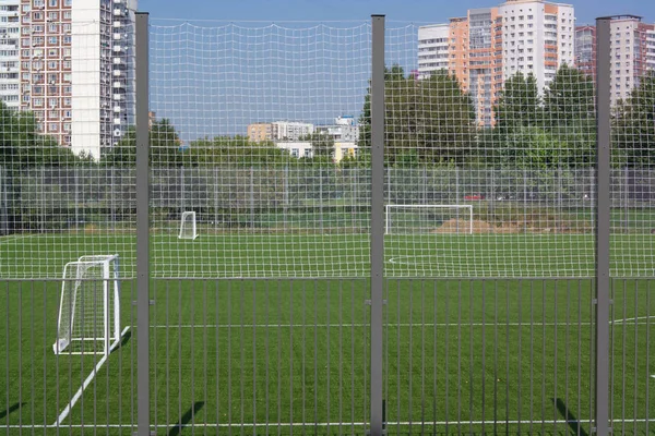 Футбольне поле біля паркану вдень сонячний день — стокове фото