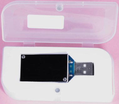 gün, pembe bir arka plan üzerinde plastik durumda elektronik cihaz