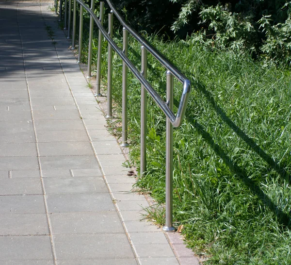 Metal fence in park at dry sunny summer day — Stock Photo, Image