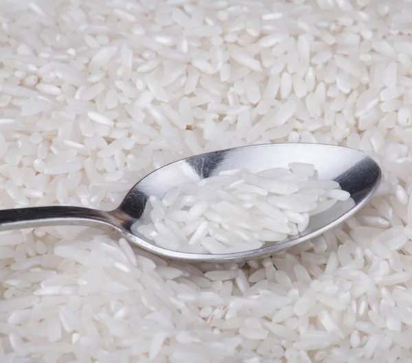 Rice food background and teaspoon — Stock Photo, Image