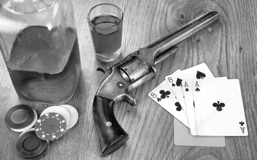 Dead mans hand aces and eights with Wild Bill's six shooter in black and white.