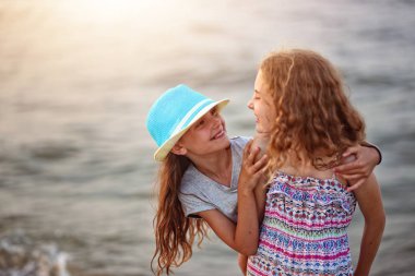     güneşli bir akşamı kumsalda mutlu arkadaşlar gülmek