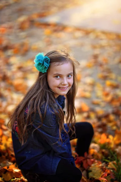 一个年轻女孩在秋园微笑 — 图库照片