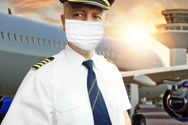 Airplane captain pilot in mask on airport