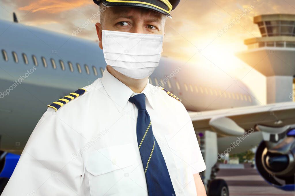 Airplane captain pilot in mask on airport