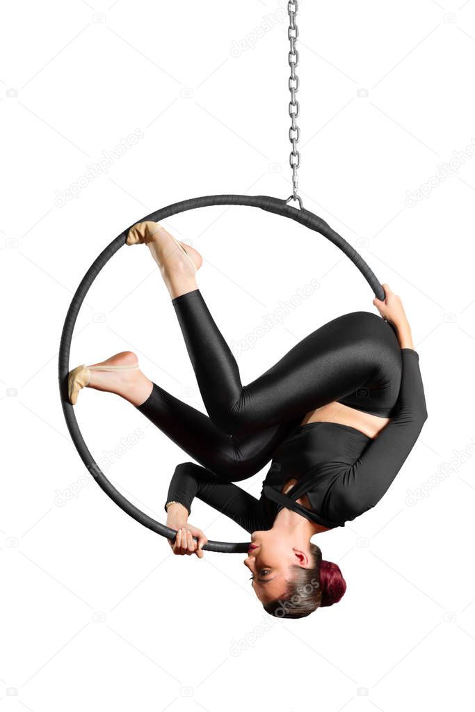 Young woman doing gymnastic exercises on the hoop isolated