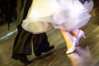 Legs of young dancers on the dance floor clipart