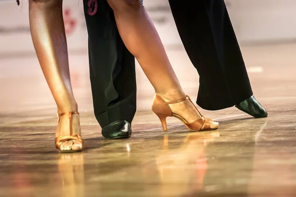 legs of a couple who dance in competition