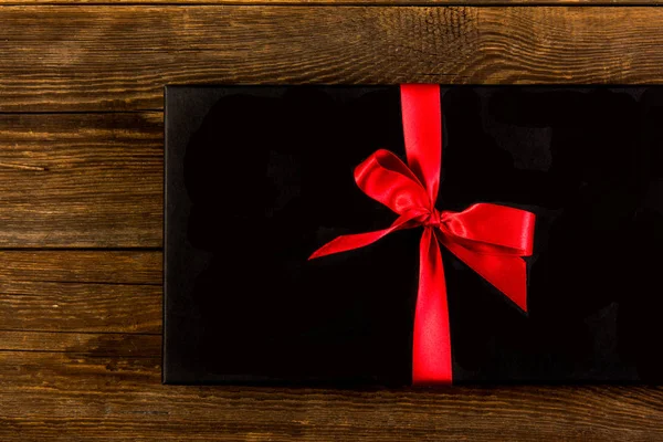 Red ribbon on a black background — Stock Photo, Image