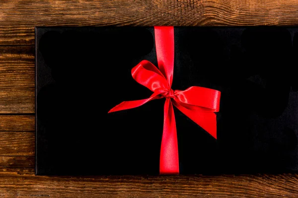 Red ribbon on a black background — Stock Photo, Image