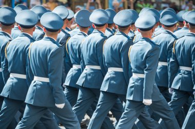 Army soldiers in blue uniform marching on military parade clipart