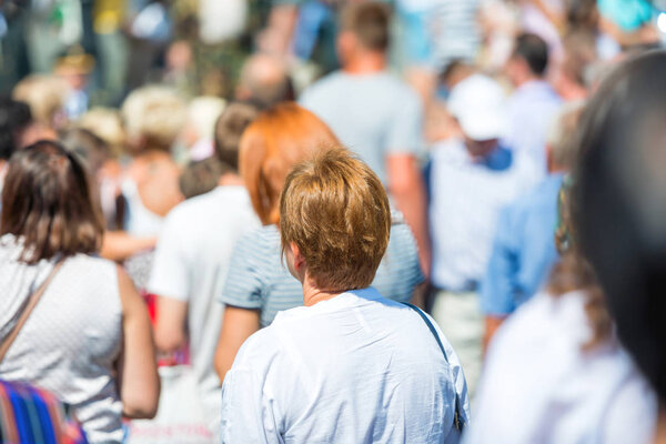 Woman in crowd of people on city street