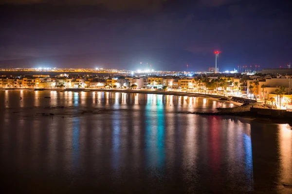 Widok nocny oświetlonego nadmorskiego miasteczka — Zdjęcie stockowe