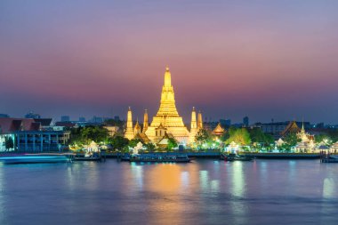 Gece, Şafak Tapınağı 'nı ya da Wat Arun' u ve günbatımında Chao Phraya Nehri 'ndeki yansımasını aydınlattı. Bangkok, Tayland