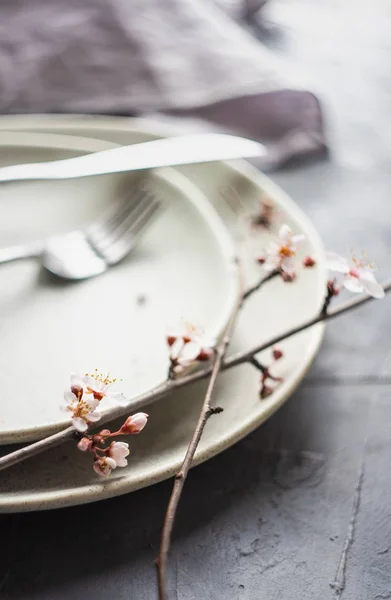 Spring table setting with blooming tree branch — Stock Photo, Image