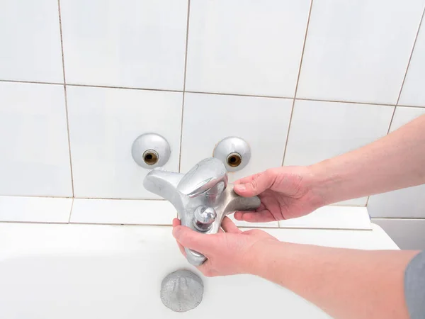 Plumber holding a dual outlet shower faucet — Stock Photo, Image