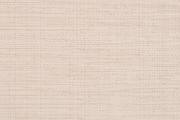 close up of a woolen fabric of beige color. Abstract background, empty template. Top view.