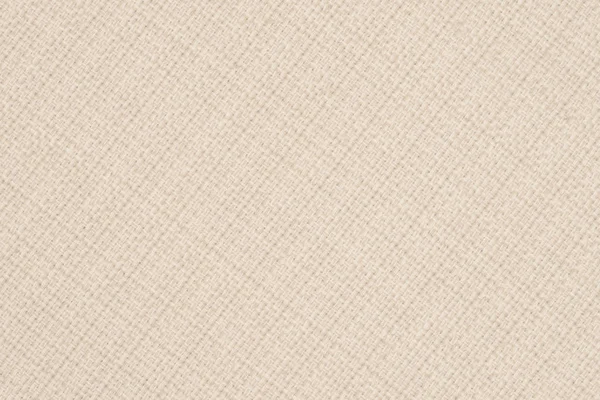 Close up of a woolen fabric of beige color. Abstract background, empty template. Top view.