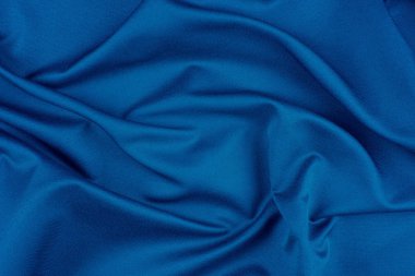 Tekstil ve doku konsepti. Buruşuk kumaş arkaplanının kapağı. Soyut arkaplan, boş şablon. Üst görünüm.