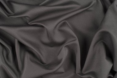 Tekstil ve doku konsepti. Buruşuk kumaş arkaplanının kapağı. Soyut arkaplan, boş şablon. Üst görünüm.