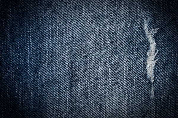 Denim jeans texture or denim jeans background with old torn. Old grunge vintage denim jeans.