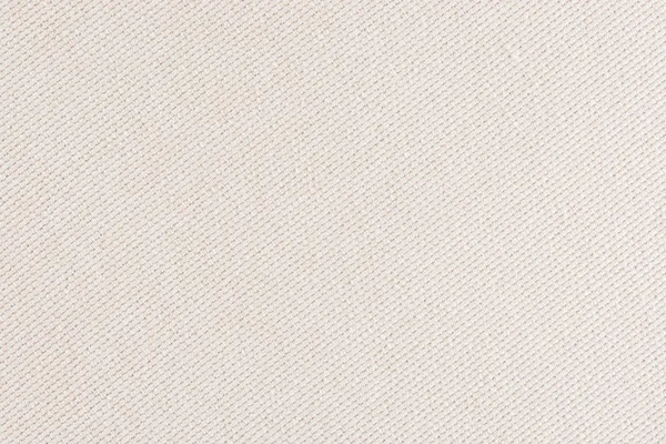 close up of a woolen fabric of beige color. Abstract background, empty template.