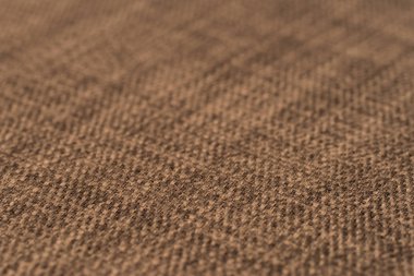 Kahverengi kumaş dokusu. Arka plan boş şablon. Seçici odak.