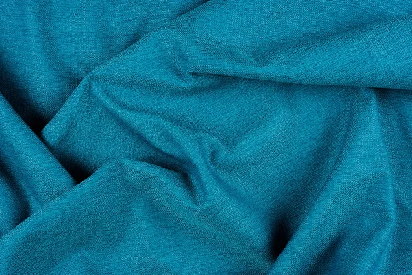 Fényes kék szövet textúra redőkkel. — Stock Fotó