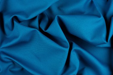 Katlı parlak mavi kumaş dokusu.