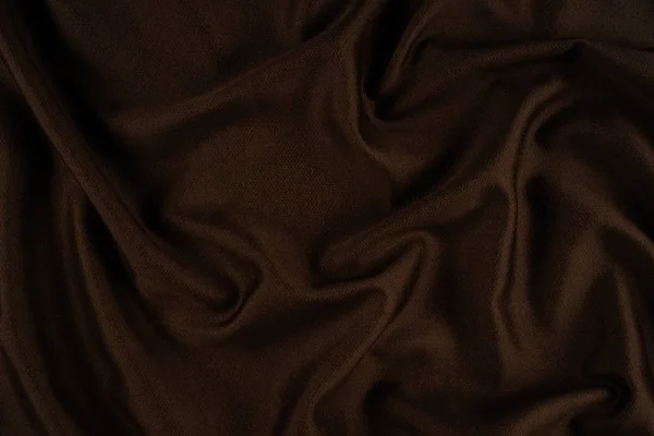 Textura de tecido marrom escuro de perto. Ondas têxteis . — Fotografia de Stock