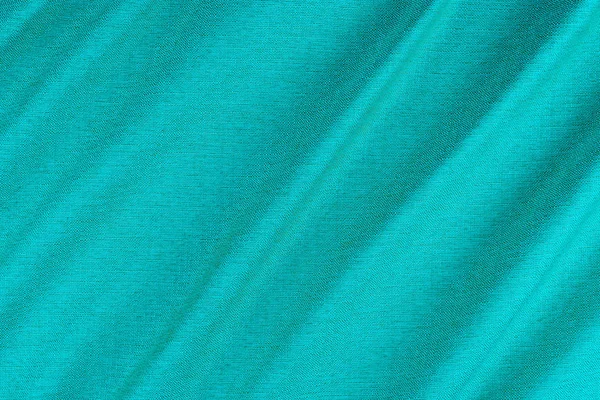 Bright blue fabric texture with folds. — Stock Photo, Image
