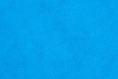 Arka plan olarak mavi renkte kırışıklıklar ile yüzey sahte deri veya