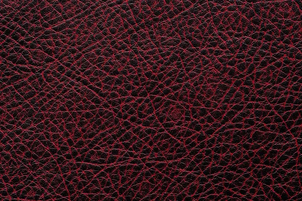Dark red leather surface as a background, leather texture.