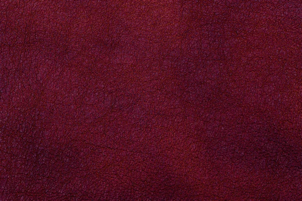 Dark red leather surface as a background, leather texture.