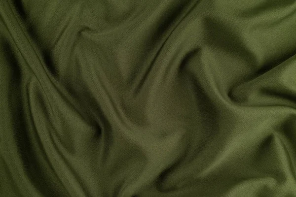 Zöld háttér összegyűrt ruhákat darab szövet. — Stock Fotó