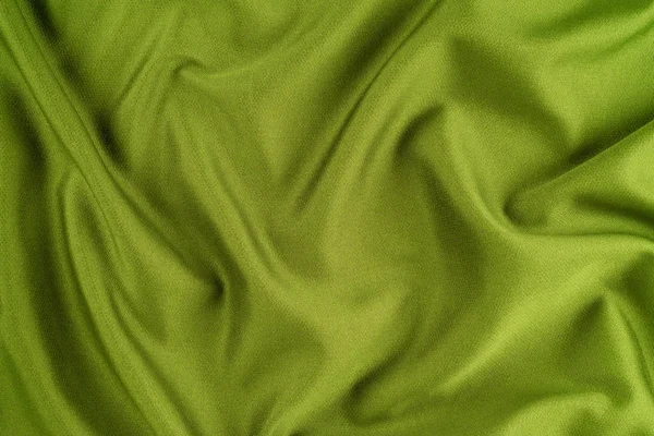 Sfondo verde di tessuto da un pezzo di vestiti spiegazzati . — Foto Stock