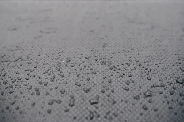 Water drops on car carbon. Dark wallpaper — Stock Photo, Image