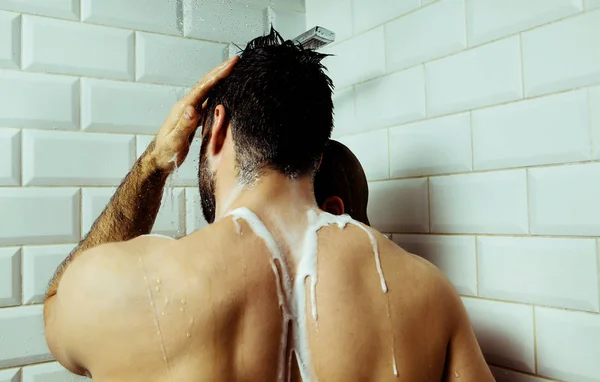 Jeune couple prenant une douche . — Photo