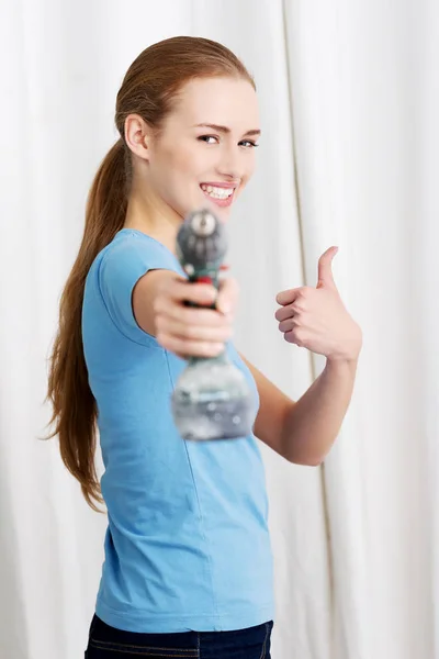Casual beautiful house wife holding drill. — Stock Photo, Image
