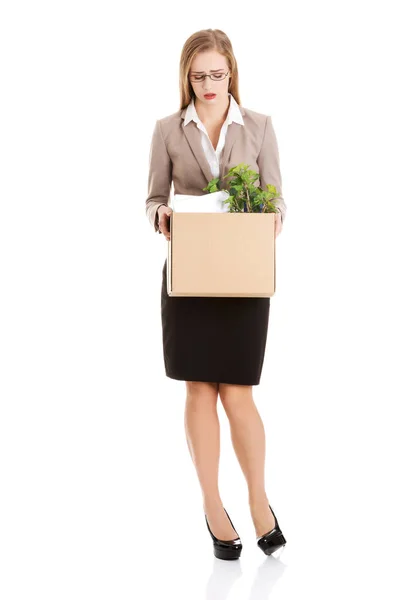 Beautiful caucasian business woman is sad because she was fired from work and is holding box with her personal things. — Stock Photo, Image