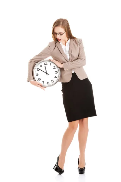 Young caucasian business woman holding clock. Stock Photo